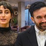 MAMDANI Tax Day THREAT — Families Flee Overnight… Two professionals engaged in conversation in a modern office setting