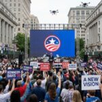 COVID Cash Vanished—Congresswoman FLEES Minutes Before Expulsion… Crowd at a political rally holding signs and watching a speaker on stage