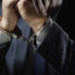 Noncitizen MAYOR Caught Voting Illegally—Now Faces Deportation… Man in suit wearing handcuffs.