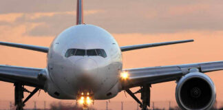 Airplane on runway during sunset.