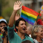 Fidel’s Daughter HINTS at Trudeau Mystery… Man waving in a crowd with a rainbow flag in the background