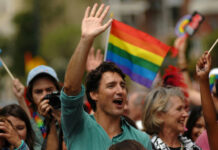 Fidel’s Daughter HINTS at Trudeau Mystery… Man waving in a crowd with a rainbow flag in the background