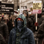 VIDEO: ICE Protests Turn Violent – Senator PEPPER-SPRAYED….. A diverse group of protesters holding signs during a march for social justice