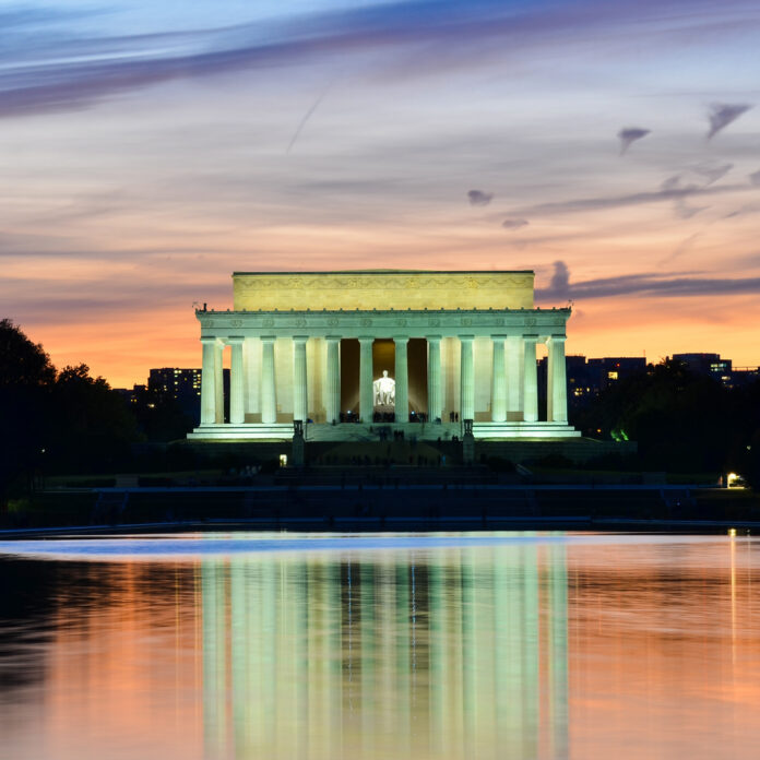 shutterstock_123870301.jpg Lincoln Memorial illuminated at sunset with reflection in water