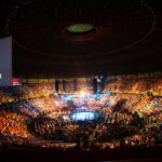 Trump’s Bold EVENT: UFC at White House! Arena filled with spectators at a UFC event.