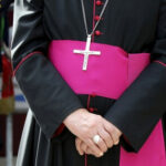 WATCH: Freemason Infiltration – Crisis Grips Catholic Church… Close-up of a cleric with cross necklace.
