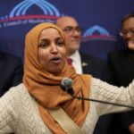 OUTRAGE: Ilhan Omar Endorses Al-Qaida Linked Candidate…. Ilhan Omar speaking passionately at a podium with a group of supporters behind her
