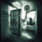 DOOMSDAY Dream Turns Lawsuit Nightmare… A dark, abandoned room with a mysterious figure in the background