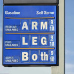 July 1 Pump Shock Hits Six States Gasoline price sign with humorous mode of payment.