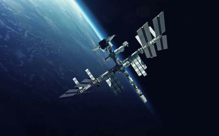 551379514 Space station orbiting Earth surrounded by dark sky.