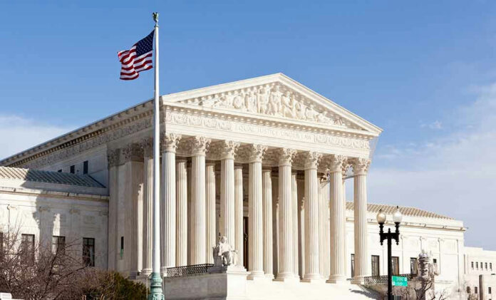 96721225-2 United States Supreme Court building with American flag.
