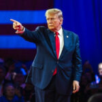 TRUMP TORCHES Netanyahu On The WORLD STAGE! Man in suit pointing on a stage.