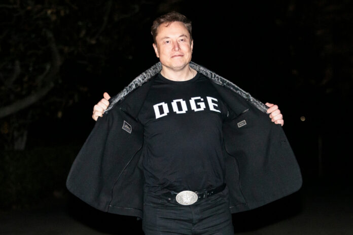 shutterstock2596219333jpg Man opening his coat to show a graphic T-shirt at night