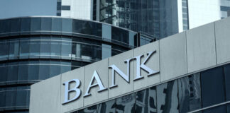 Bank building facade with large sign and glass windows
