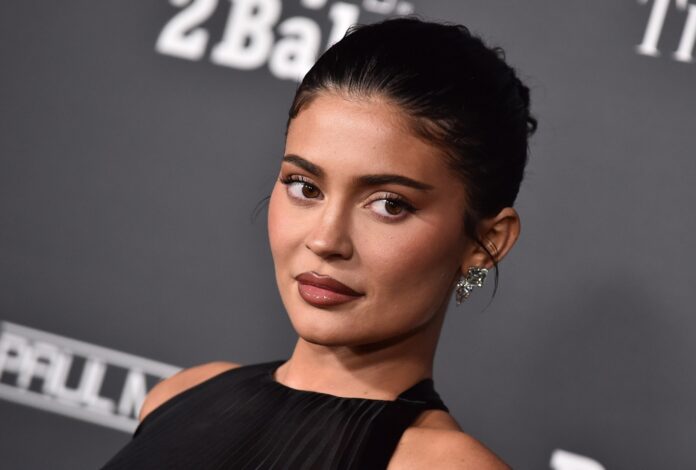 Los,Angeles,-,Nov,12:,Kylie,Jenner,Arrives,For,Baby2baby Luxury mansion surrounded by police and a helicopter in the Hollywood Hills at dusk