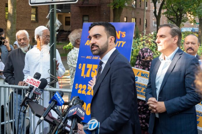 Democratic,New,York,City,Mayoral,Candidate,Zohran,Mamdani,Launches,A Person handing over house keys to another.