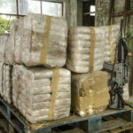 BIZARE WAY Massive HAUL of Heroin Was CLEVERLY DISGUISED Pallet with large wrapped packages and an assault rifle.