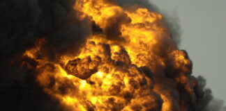 A large explosion with flames and thick smoke billowing into the sky