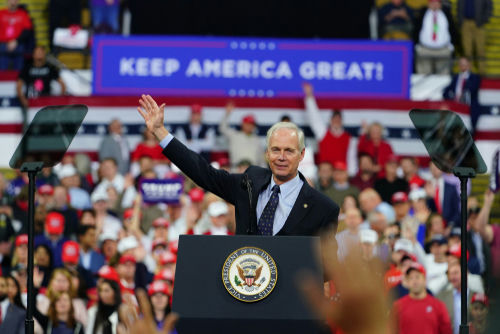 shutterstock1620801484jpg Politician speaking at rally with Keep America Great! sign.
