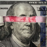 Beijing Tightens The Noose On US Money Torn dollar revealing Chinese yuan behind Benjamin Franklins eyes.