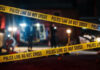Safety Lapses Exposed — Bangkok’s Nightmare Yellow police tape at a nighttime crime scene.