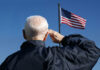 Elderly man saluting the American flag