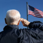 Storm Shelter Stunner: 103-Year-Old Leads Anthem Elderly man saluting the American flag