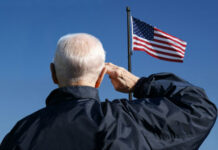 Storm Shelter Stunner: 103-Year-Old Leads Anthem Elderly man saluting the American flag