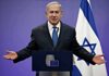 City Hall Bluff Exposed In Netanyahu Fight man in suit speaking at a podium with Israeli flag