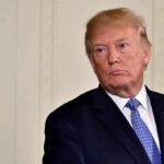 America First Crushes Career Diplomats man in suit with blue tie looking to the side