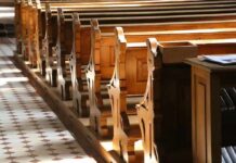 Parents Outraged—$25M Bombshell Hits Church wooden church pews in sunlight