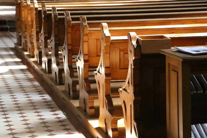 shutterstock_1152589436 wooden church pews in sunlight