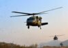 Local Choppers Upstage Big Bureaucracy Military helicopters flying low over a dry landscape