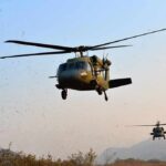 Local Choppers Upstage Big Bureaucracy Military helicopters flying low over a dry landscape