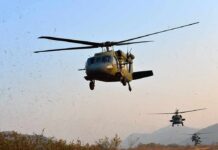 Local Choppers Upstage Big Bureaucracy Military helicopters flying low over a dry landscape