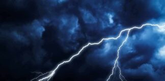 Lightning bolts streak across dark storm clouds
