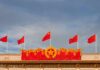 Chinese flags atop a decorated building facade