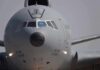 Front view of a large military cargo aircraft on the runway
