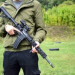 Gun Ban Crumbles — Supreme Showdown Next person holding a black rifle outdoors