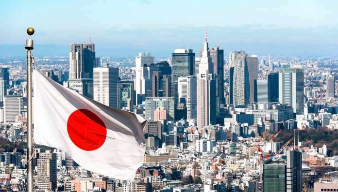 shutterstock_2178321981-2 Japanese flag waving with modern city skyline in background