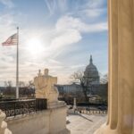U.S. Squeeze Tightens On Megaupload King White building with columns under a blue sky.