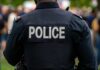 Closed-Door Vote, Million-Dollar Cop Payday Back view of a police officer in uniform at a public event