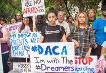 People protesting with signs supporting DACA and Dreamers.