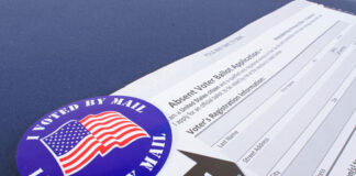 Mail-in ballot application with "I Voted By Mail" sticker.