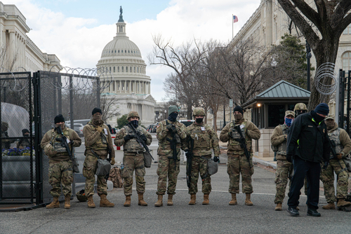 Soldiers standing guard in front of United States Capitol.