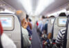 People seated inside an airplane cabin.